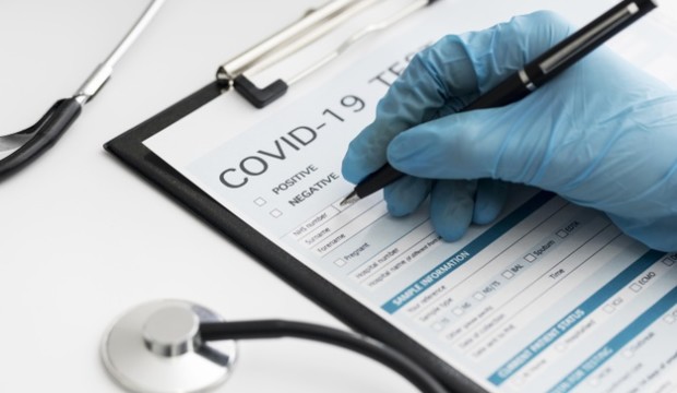 close-up-doctor-completing-covid-medical-form_23-2148747819
